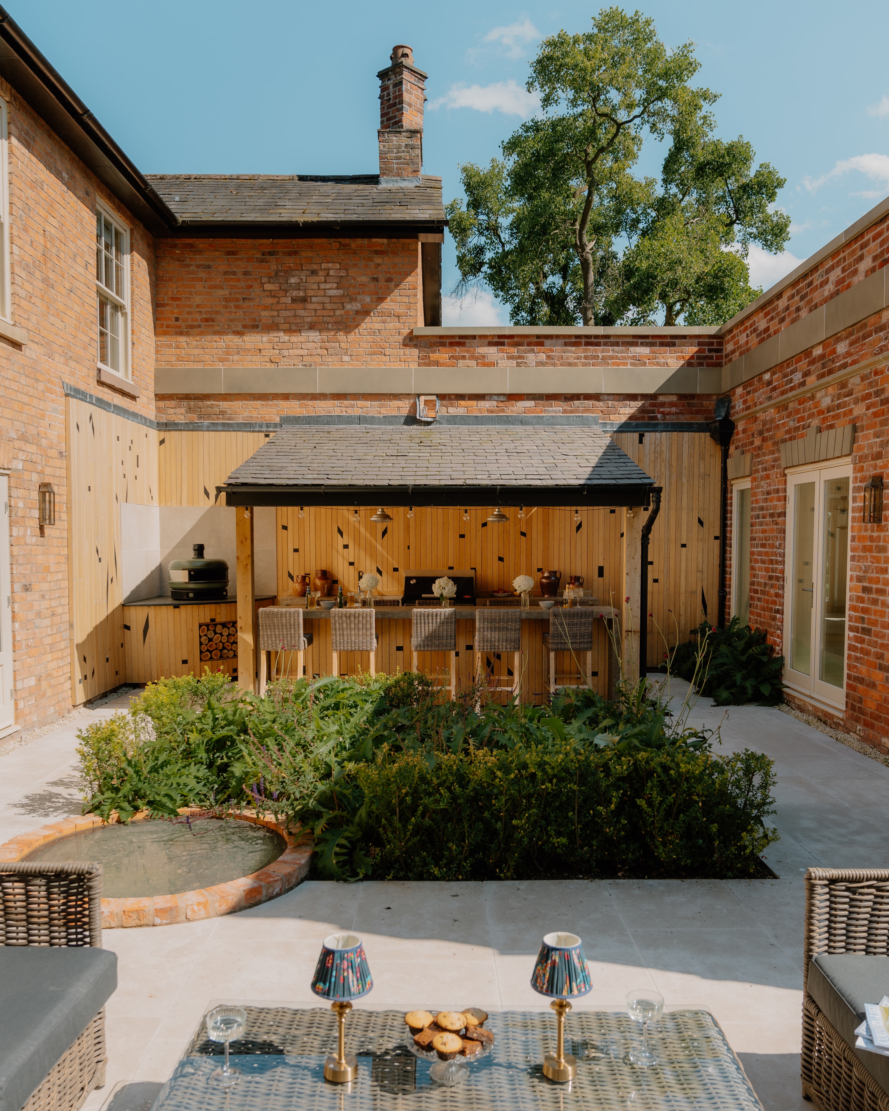 Beautifully crafted courtyard with outdoor kitchen and garden at Foxdale